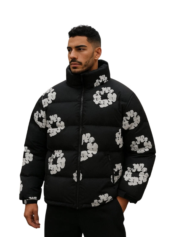 Man wearing a black puffer jacket with white floral patterns on a white background