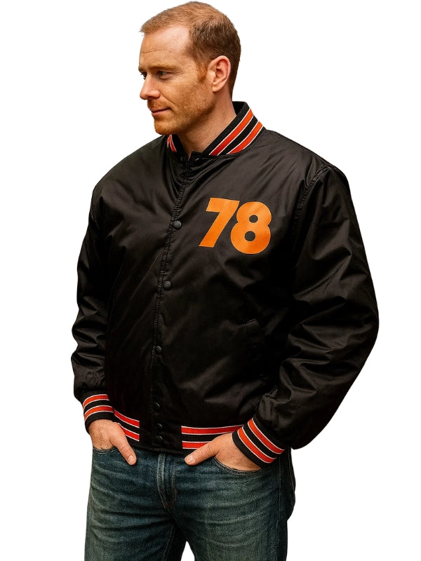 Man wearing a black jacket with orange number 78 on a white background