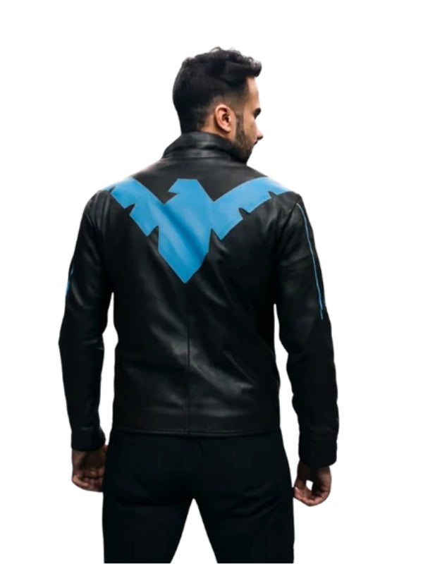 Person wearing a black leather jacket with a blue logo on the back against a white background