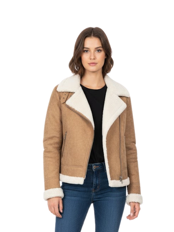 Woman wearing a brown shearling jacket with white lining on a white background