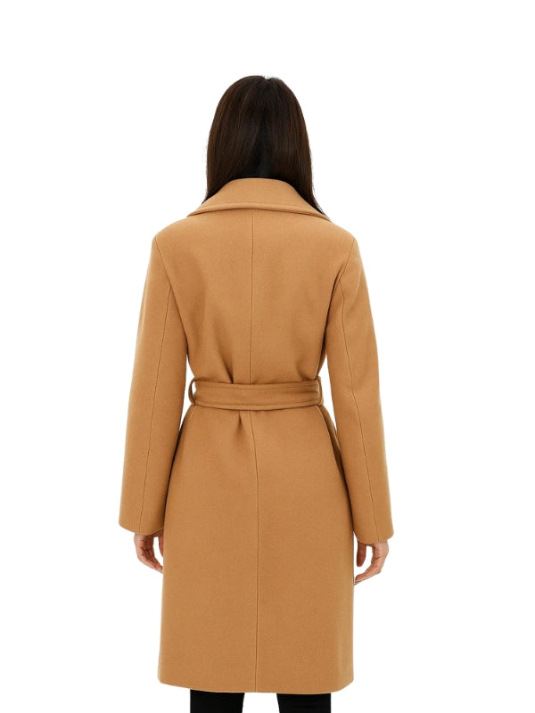Woman wearing a tan coat on a white background