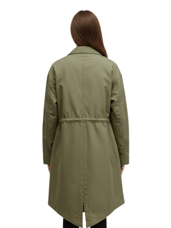 Person wearing a green trench coat on a white background
