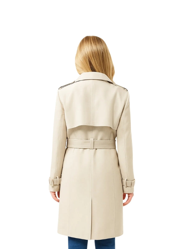 Woman wearing a beige trench coat on a white background