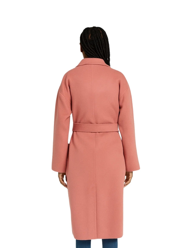 Person wearing a pink coat on a white background