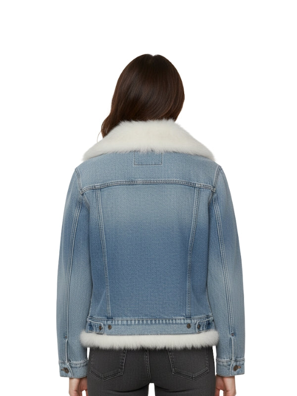 Blue denim jacket with white fur trim worn by a person on a white background