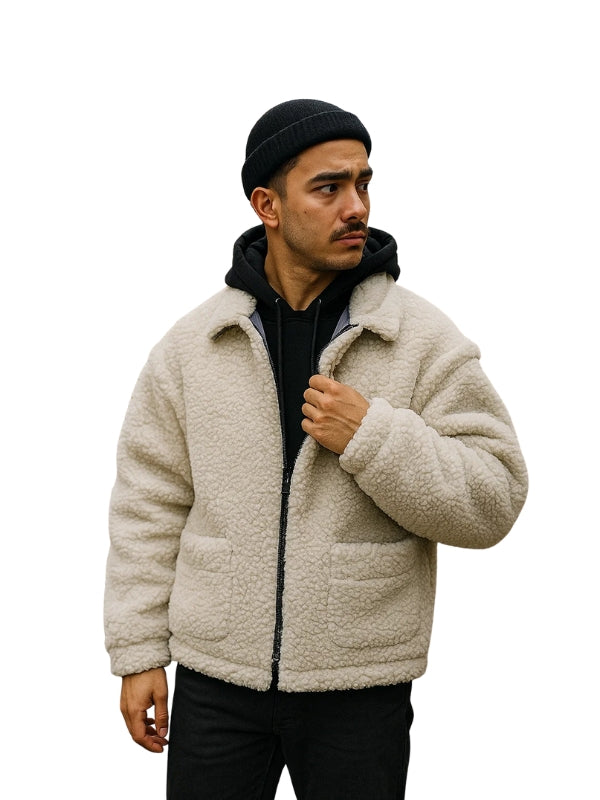 Man wearing a beige sherpa jacket and black beanie on a white background