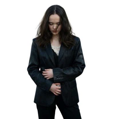 Woman wearing a black suit on a white background