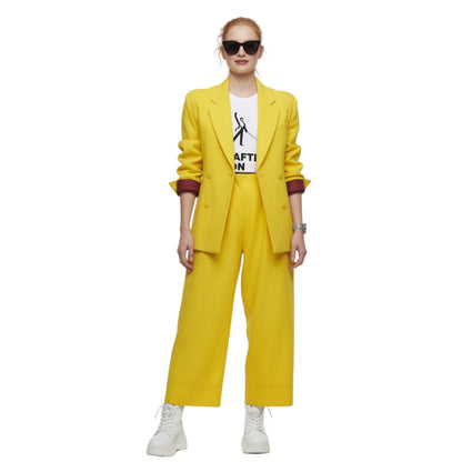 Person wearing a yellow suit with a white shirt underneath on a white background
