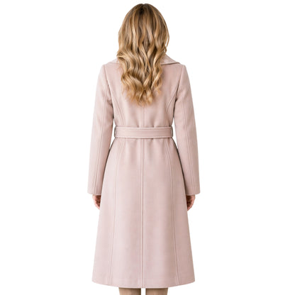 Woman wearing a long pink coat on a white background