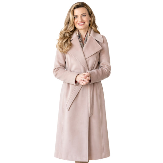 Woman wearing a light pink coat on a white background