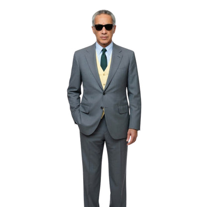 Man wearing a gray suit with a green tie on a white background