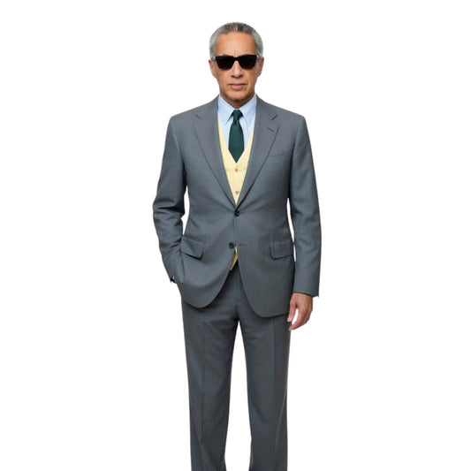 Man wearing a gray suit with a green tie on a white background
