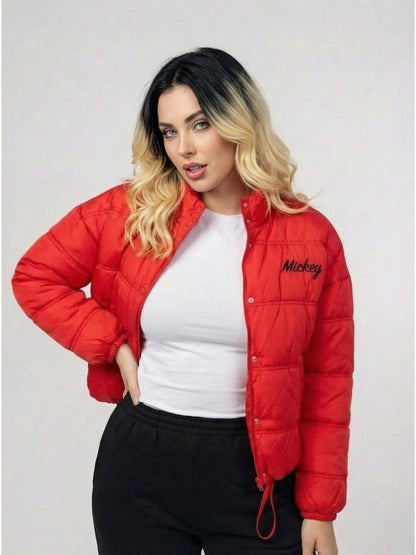 Woman wearing a red puffer jacket with 'Mickey' branding on a plain background