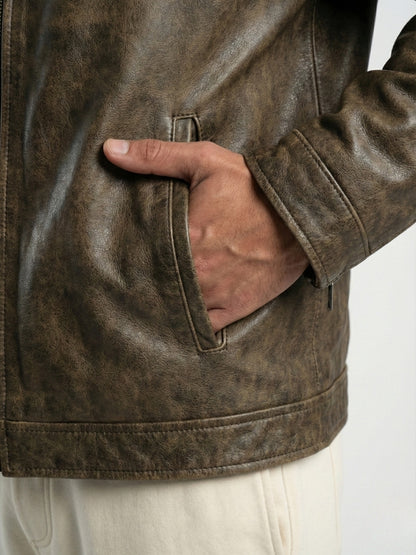 Brown leather jacket with a hand in the pocket on a white background