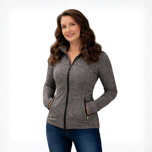 Woman wearing a gray zip-up jacket on a white background