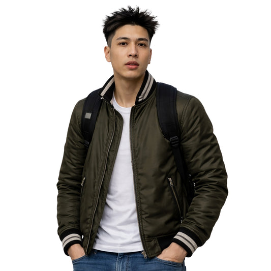 Man wearing a green bomber jacket with a white shirt and blue jeans on a white background
