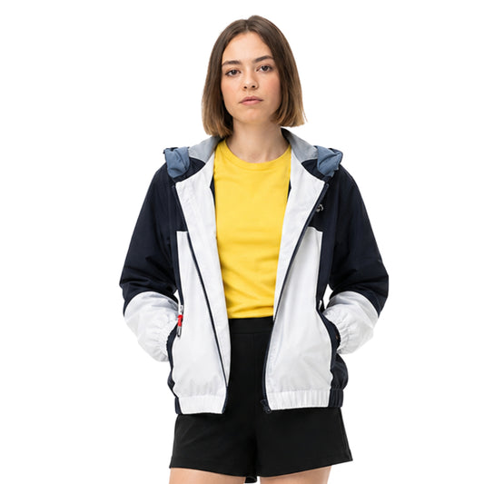 Woman wearing a black and white jacket with a yellow shirt underneath on a white background