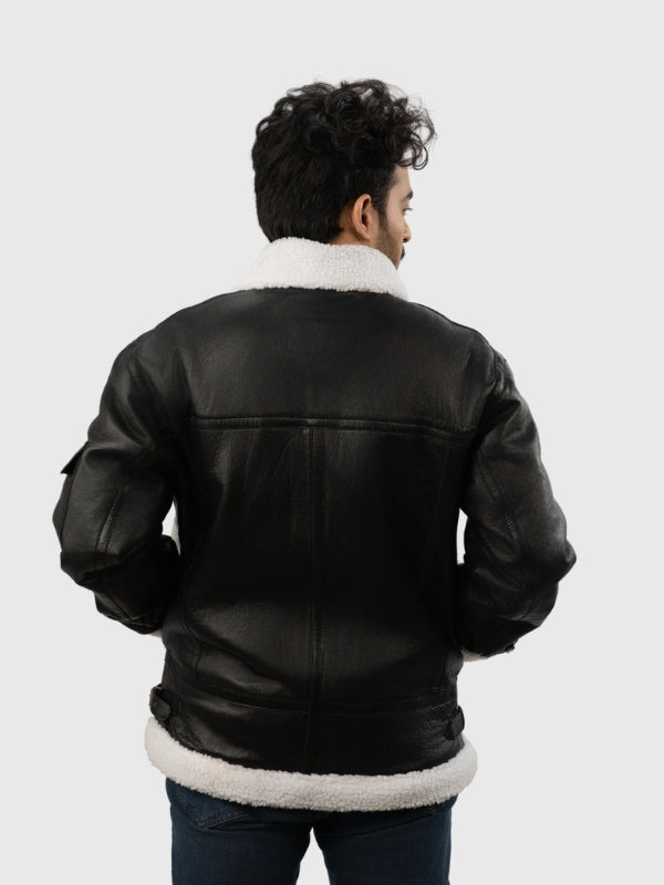 Person wearing a black leather jacket with white fur lining on a white background