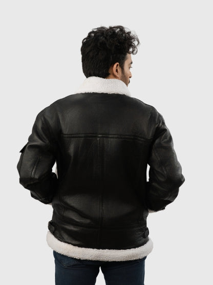 Person wearing a black leather jacket with white fur lining on a white background