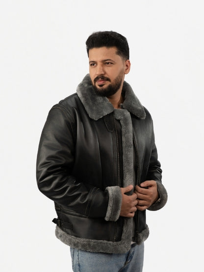 Man wearing a black leather jacket with gray fur lining on a white background