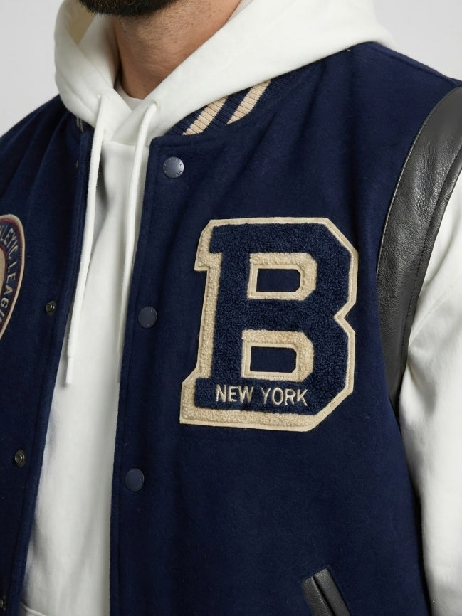 Navy varsity jacket with a large 'B' emblem on a white background