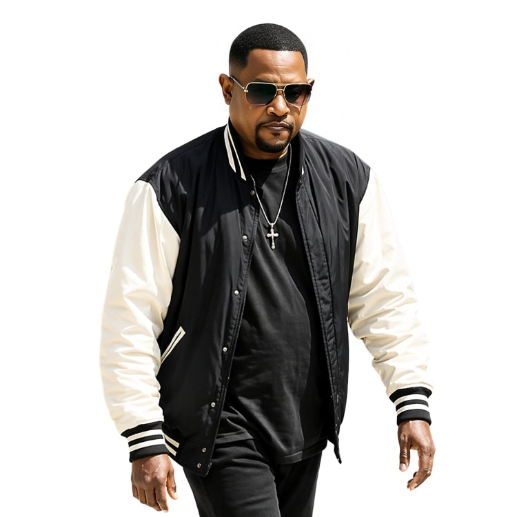 Man wearing a black and white varsity jacket with sunglasses on a white background