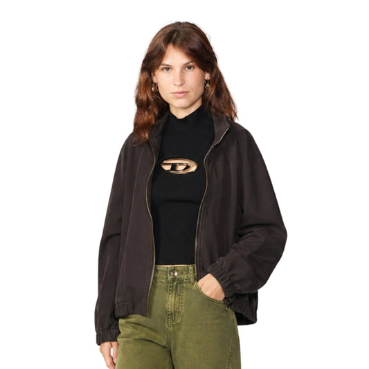 Woman wearing a black jacket and black top with cut-out design on a white background