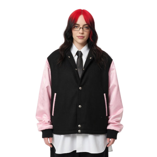 Person wearing a black and pink varsity jacket on a white background