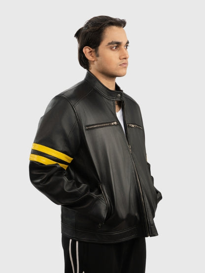 Man wearing a black leather jacket with yellow stripes on a white background