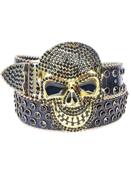 Gold skull belt buckle with black stones on a white background