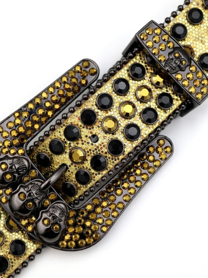Gold and black studded belt buckle on a white background