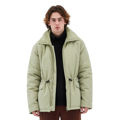 Person wearing a light green jacket on a white background
