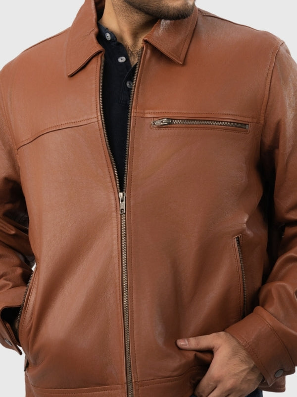 Brown leather jacket worn by a person on a white background
