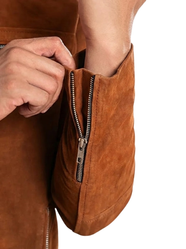 Close-up of a brown leather jacket with a zipper being pulled.
