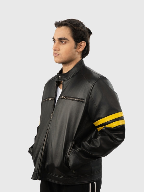 Man wearing a black leather jacket with yellow stripes on a white background