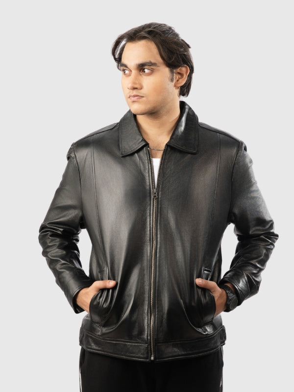 Man wearing a black leather jacket on a gray background