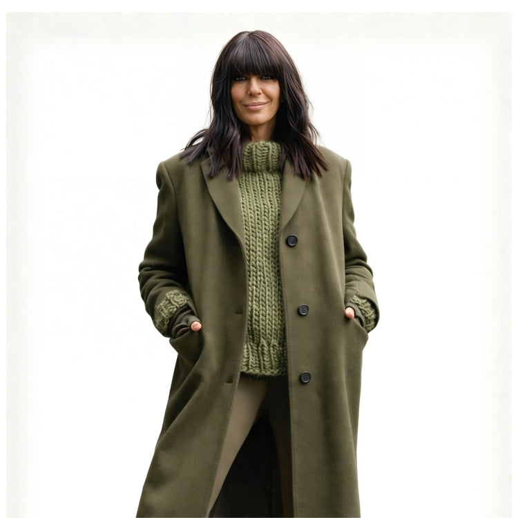 Woman wearing a green coat over a green knitted sweater on a white background