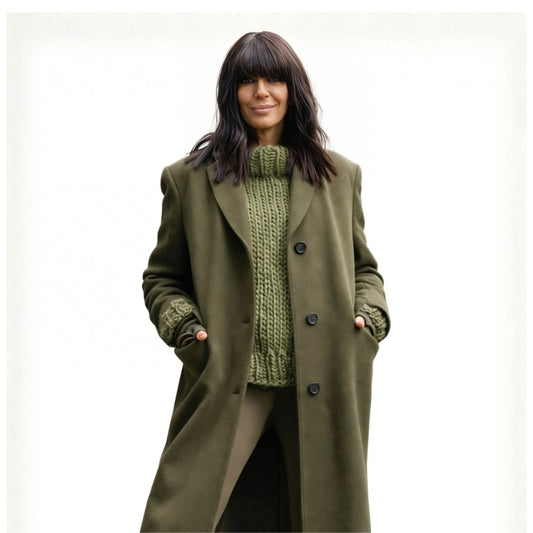Woman wearing a green coat over a green knitted sweater on a white background