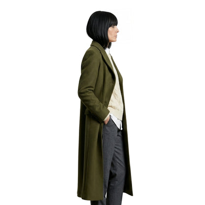 Person wearing a long olive green coat on a white background
