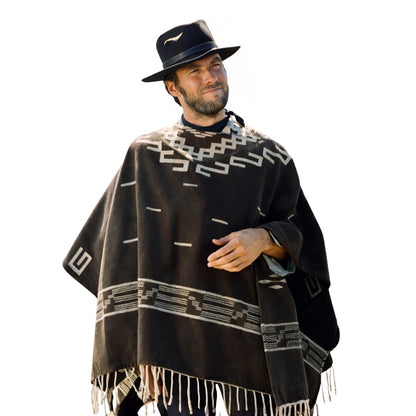Man wearing a black poncho with white patterns and a matching hat on a white background