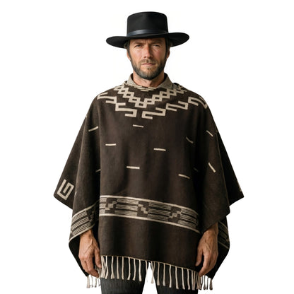 Man wearing a brown poncho with geometric patterns and a black hat on a white background