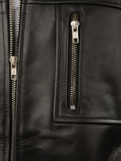 Close-up of a black leather jacket with gold zippers.