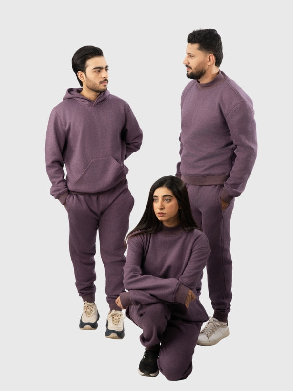 Three people wearing matching purple sweatsuits on a white background