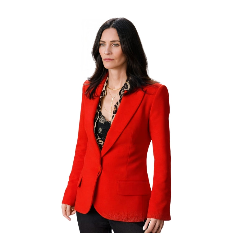 Woman wearing a red blazer over a patterned top on a white background