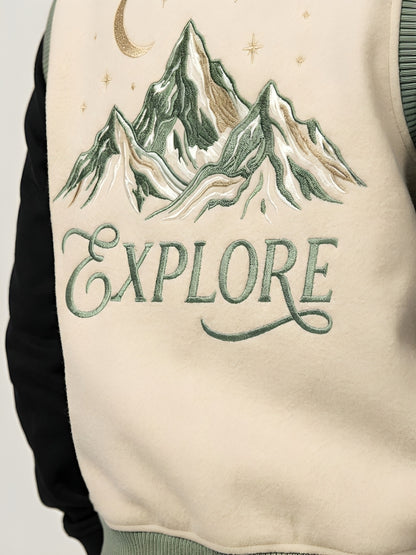 Jacket with embroidered mountain design and 'EXPLORE' text on a plain background