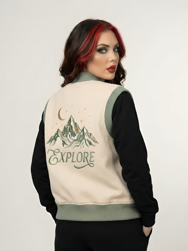 Woman wearing a jacket with a mountain design and 'EXPLORE' text on the back.