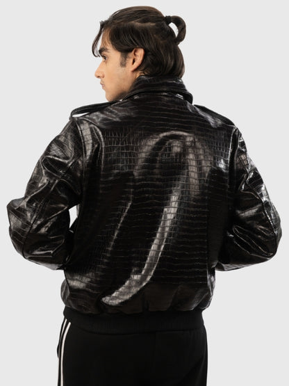 Person wearing a black leather jacket with a textured pattern on a white background