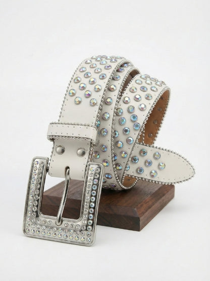 Decorative belt with rhinestones on a wooden stand against a white background