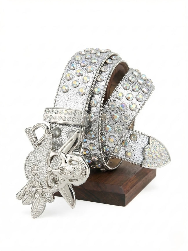 Decorative belt with crystal embellishments and a silver buckle on a white background