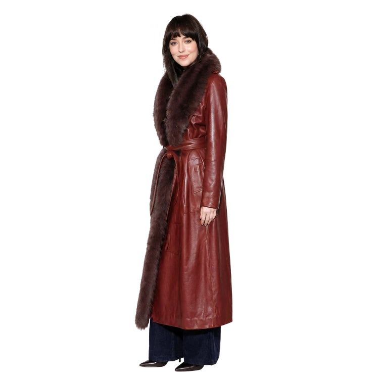 Woman wearing a long red leather coat with fur collar on a white background